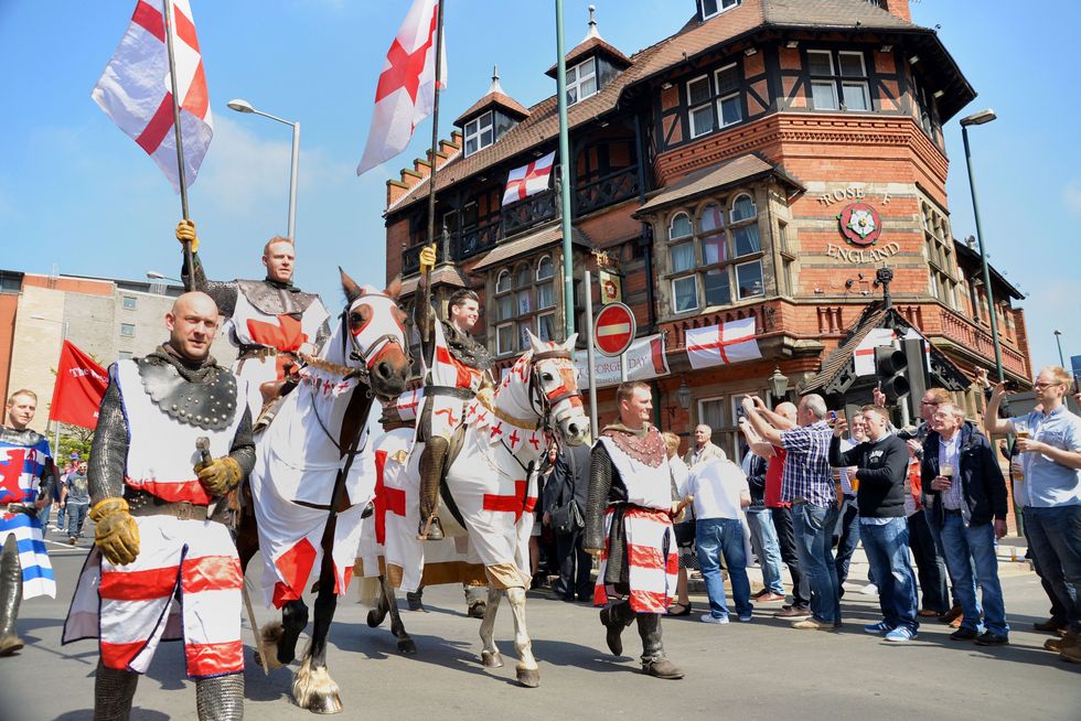 The St George's Day parade passes the Rose of England public house on its way to the city centre of Nottingham