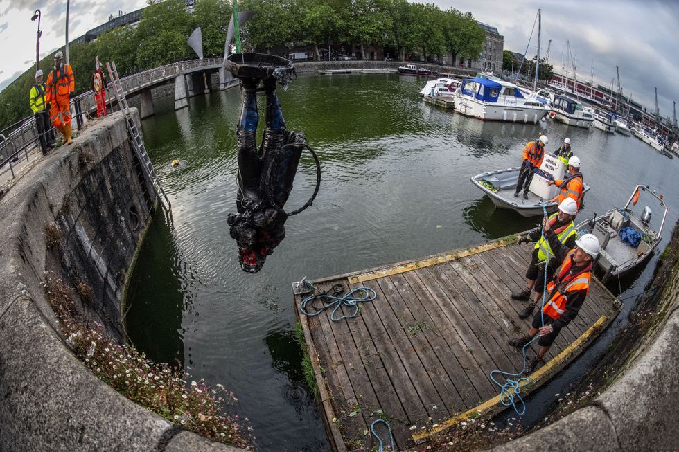 The statue of slave trader Edward Colston is retrieved from Bristol Harbour by a salvage team on June 11, 2020