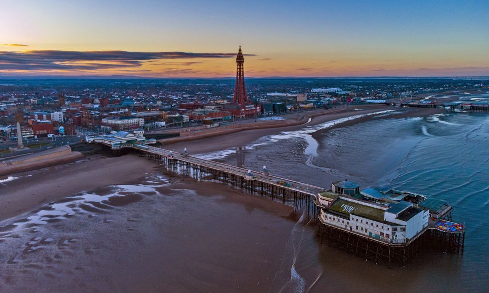 The sun rises behind the Blackpool Tower in Blackpool, Lancashire. Picture date: Friday April 2, 2021.