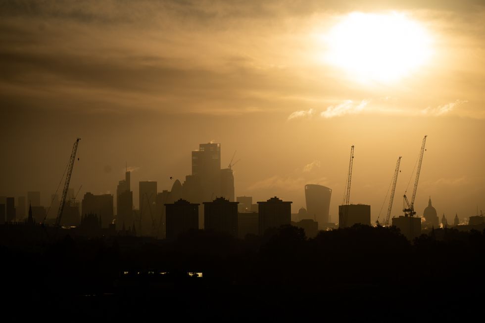 The sun rises behind the London skyline from Primrose Hill, London. Britons are set to be lashed with rain over the weekend as temperatures turn colder. Picture date: Friday November 4, 2022.
