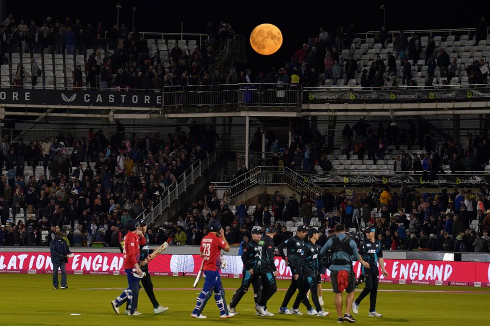 The Super Blue Moon is visible over the stands as the teams walk off after the first Vitality IT20 match at the Seat Unique Riverside