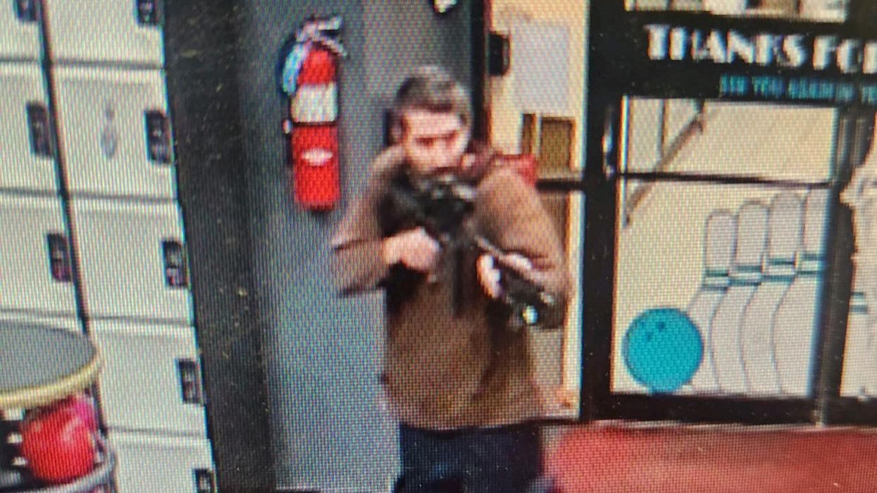 The suspect holding a gun