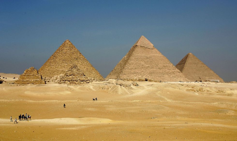 : The three large pyramids of Menkaure (L), Khafre (C) and Khufu loom over the horizon November 13, 2004 at Giza