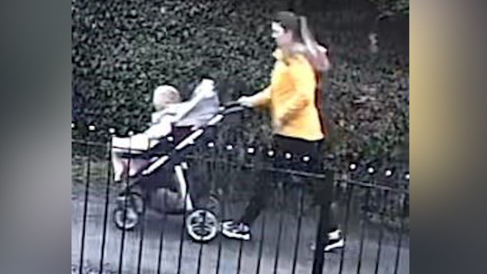 The woman photographed is wearing a yellow jacket and black jeans.