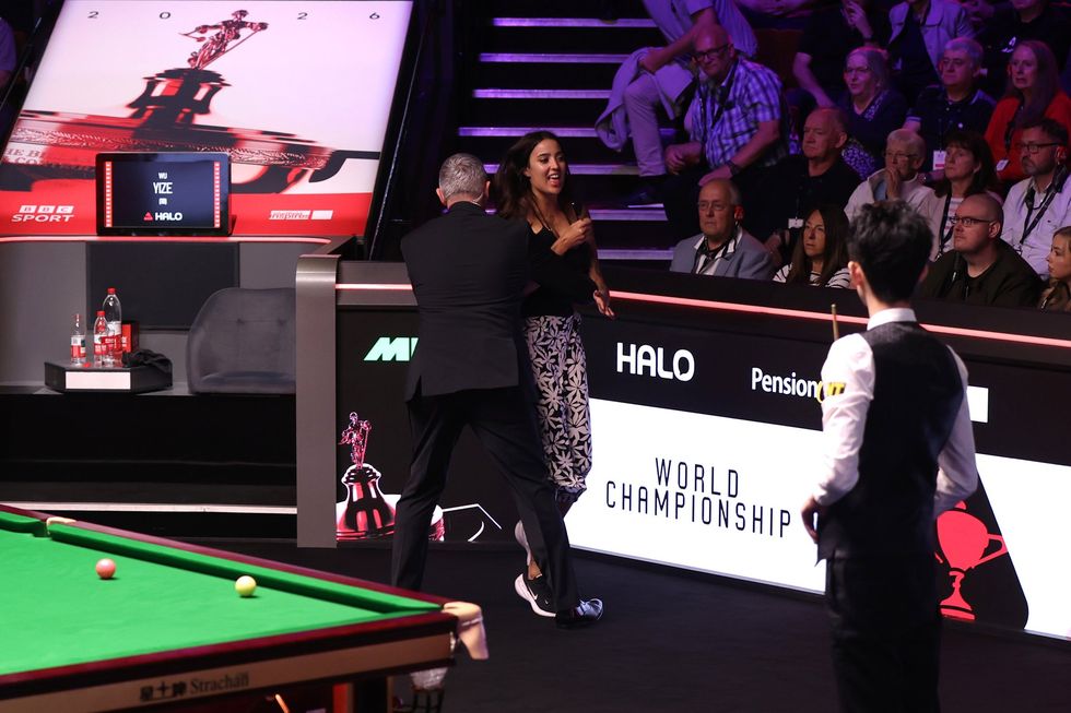 The World Championship was halted after a protestor jumped into the playing area