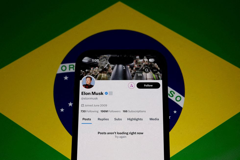 The X account of Elon Musk in seen blocked on a mobile screen
