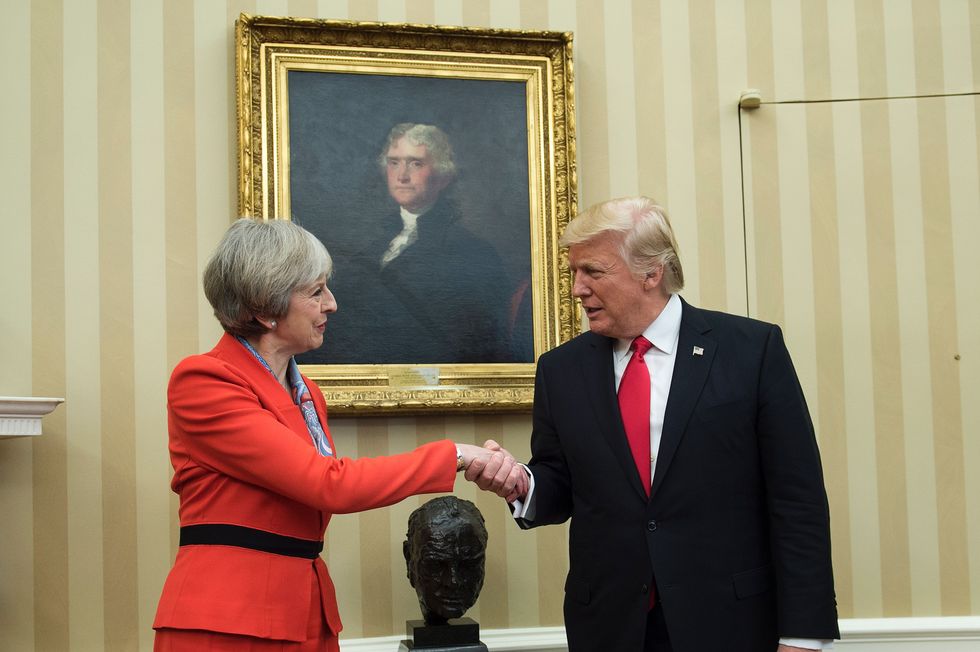 Theresa May and Donald Trump shake hands in front of Churchill bust in Oval Office