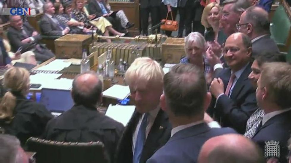 Theresa May doesn't join in with Tory ovation for Boris Johnson after his final PMQs as leader