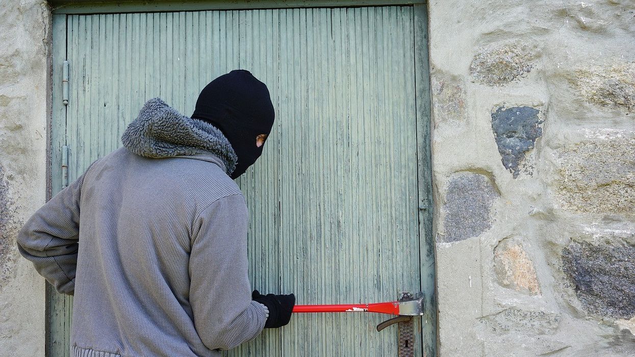 Thief trying to break into an outhouse
