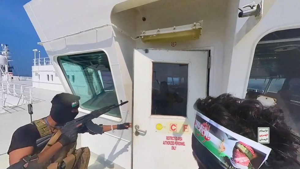 This handout screen grab captured from a video shows Yemen's Houthi fighters' takeover of the Galaxy Leader Cargo in the Red Sea coast off Hudaydah,