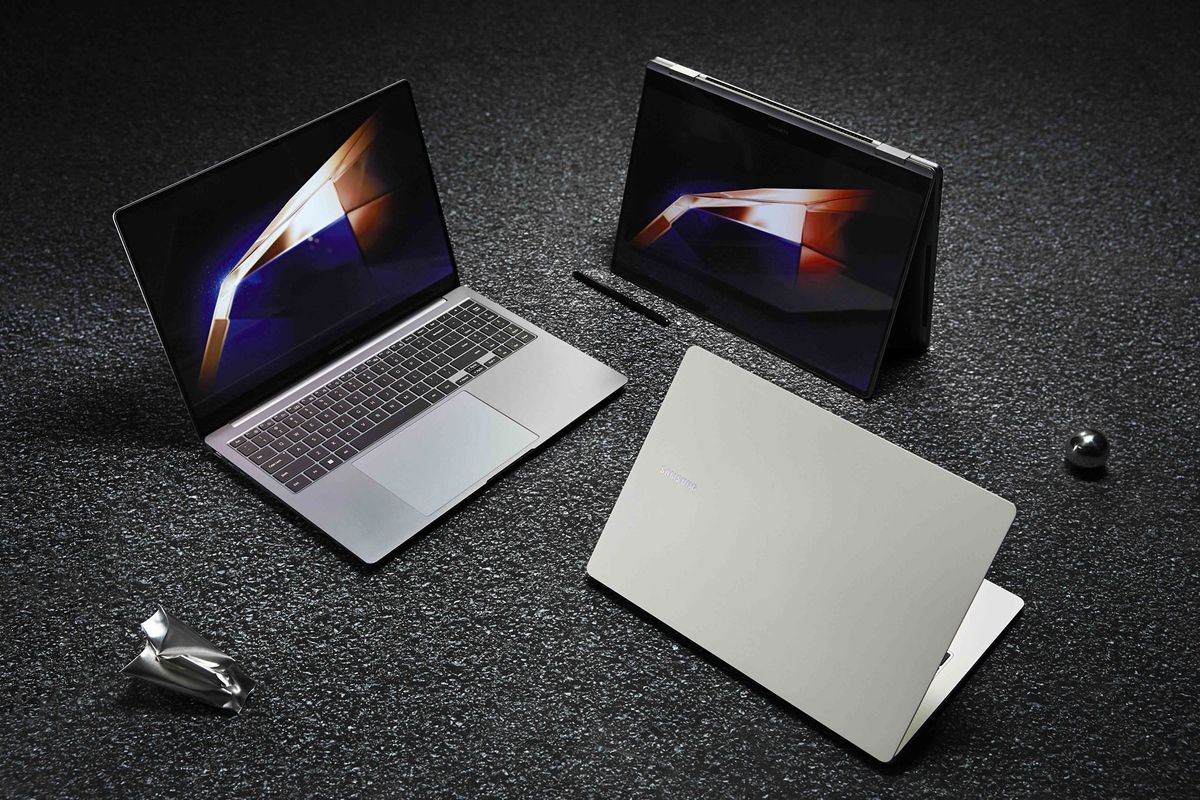 three galaxy book 4 models pictured on a textured floor with metal cubes surrounding them 