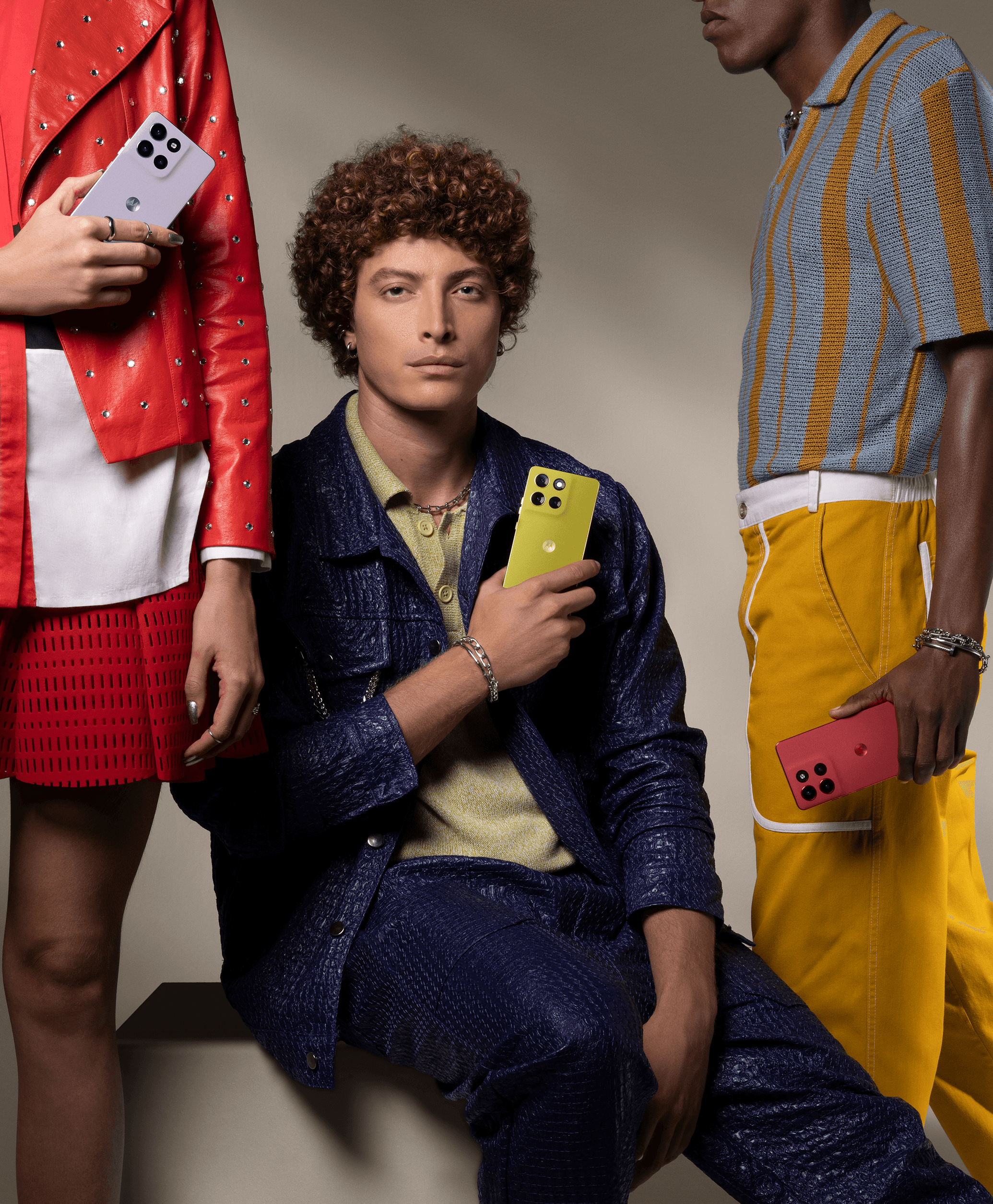 three models pictured holding the new motorola moto g