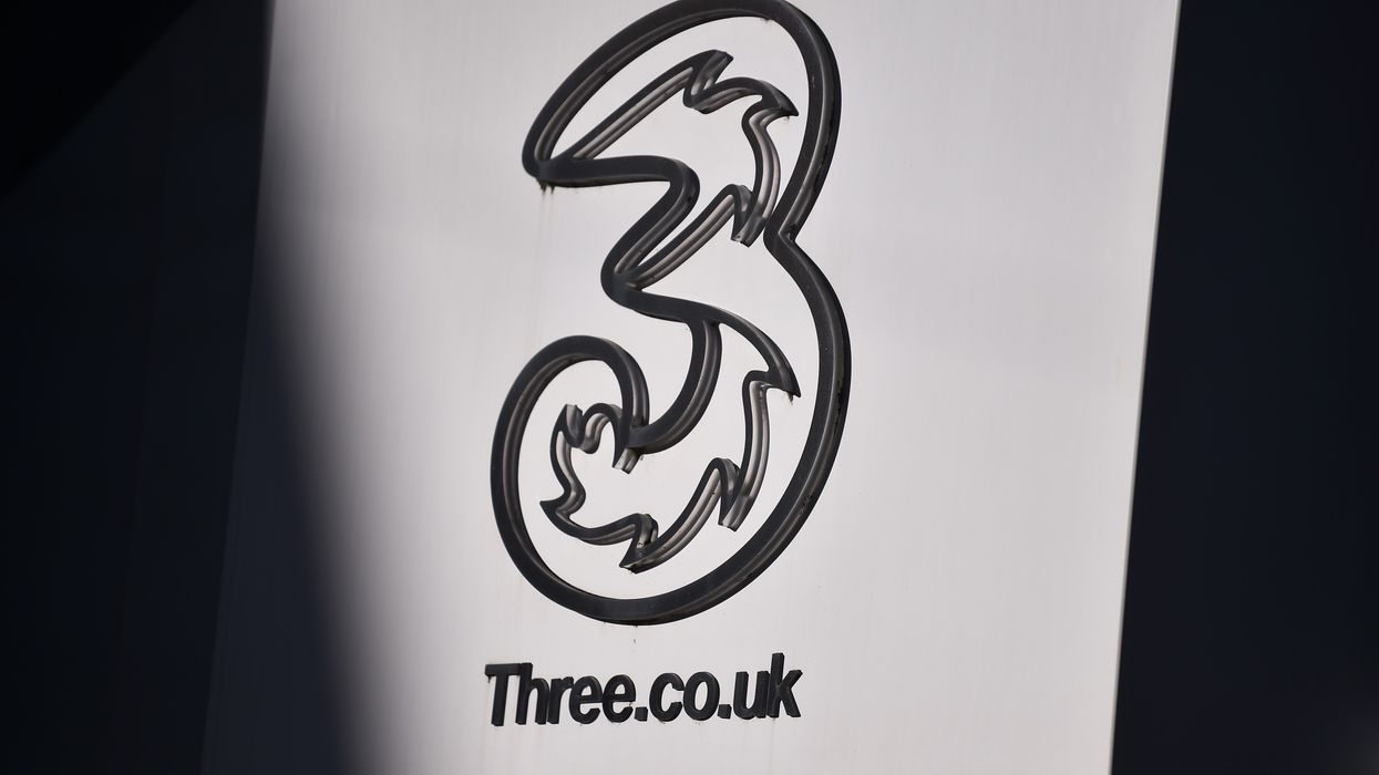 three UK mobile logo on a sign outside of a shop