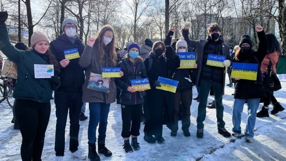 Thunberg protests with Stand with Ukraine sign