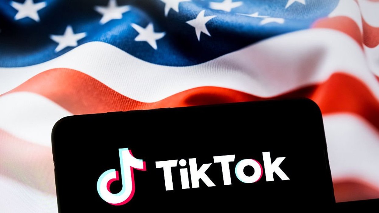 TikTok logo on phone in front of US flag
