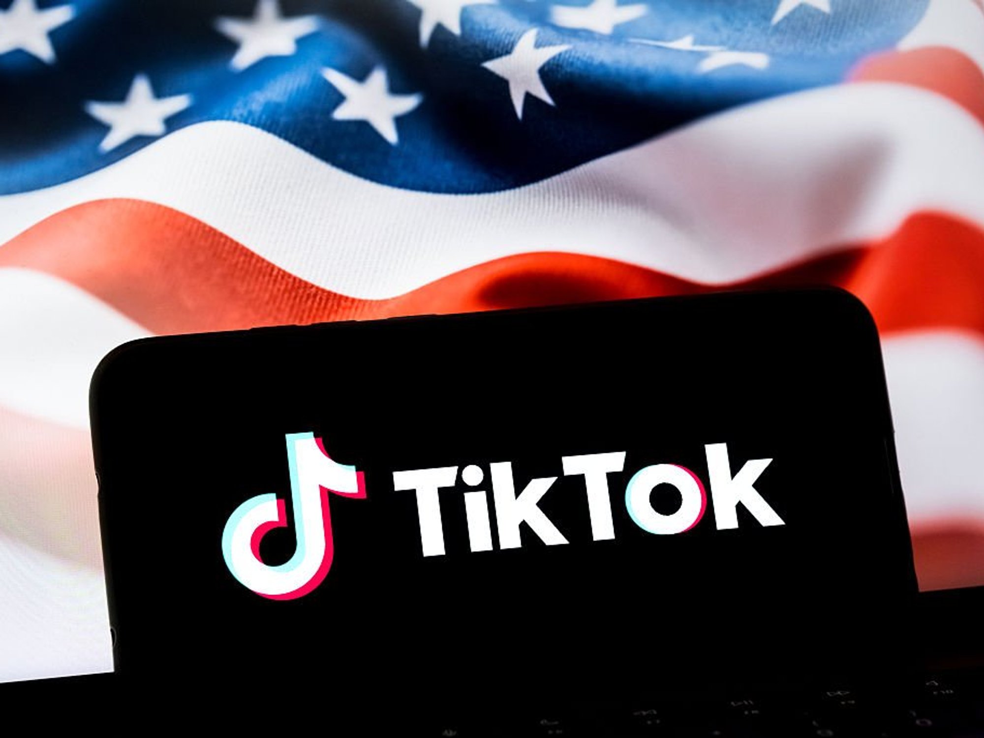TikTok logo on phone in front of US flag