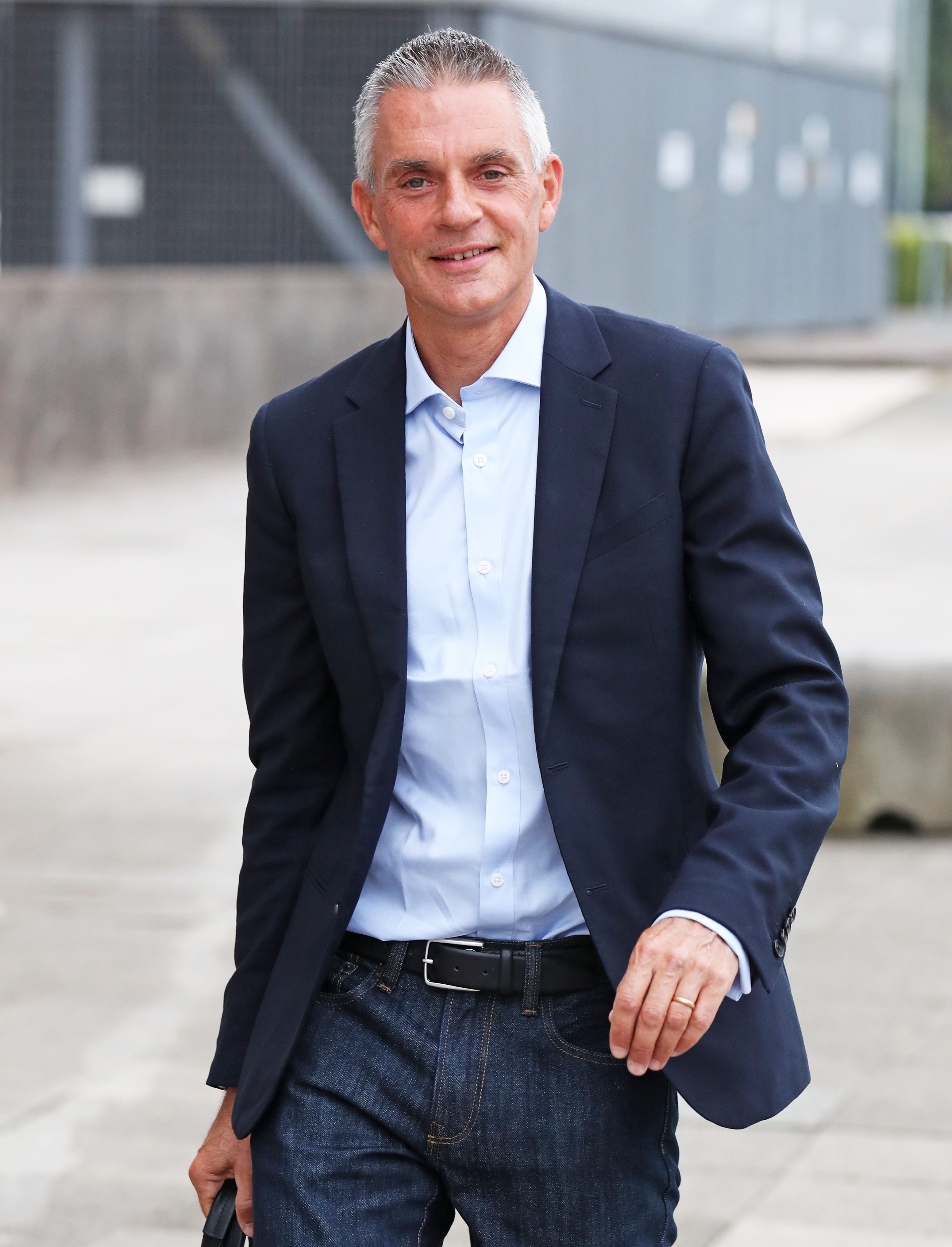 Tim Davie walking outside in London