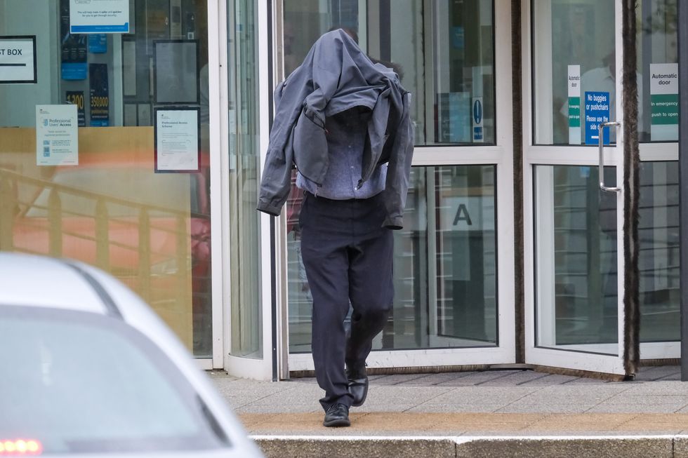 Timothy Schofield, the brother of TV presenter Phillip Schofield, covering his head as he leaves Exeter Crown Court