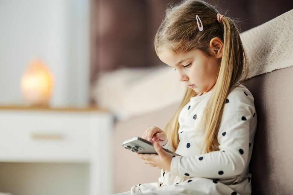 Toddler playing with a phone