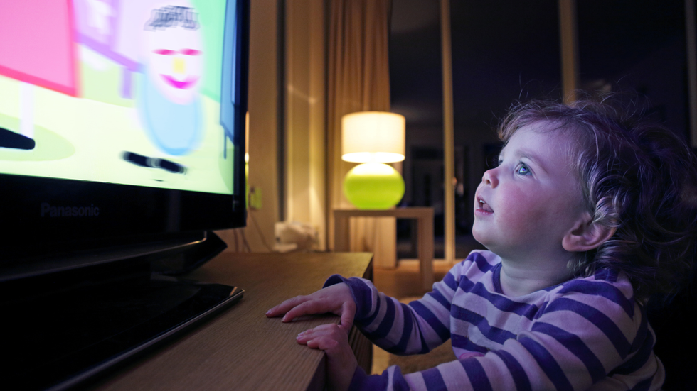 Toddler watching television screen