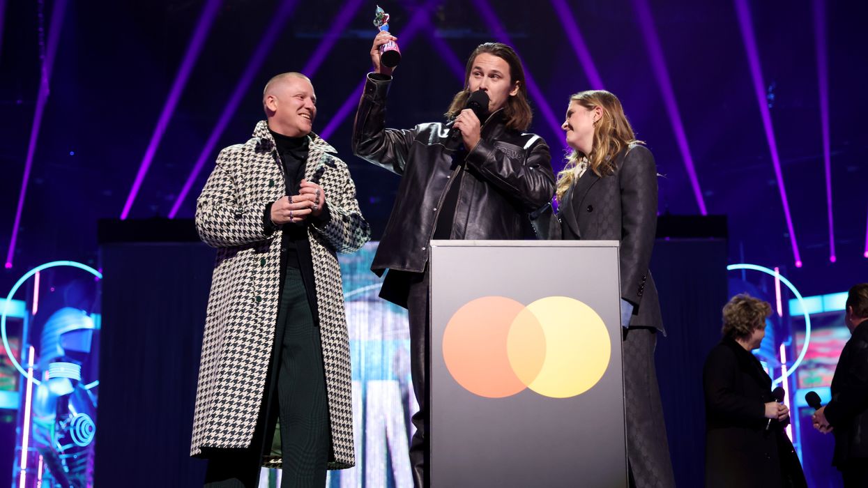 Tom McFarland, Joshua Lloyd-Watson and Lydia Kitto of 'Jungle' receive the Group of the Year Award onstage