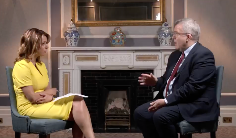 Tom Watson speaking to Gloria de Piero