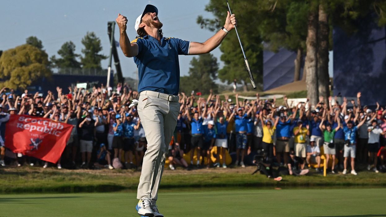 Tommy Fleetwood celebrates the winning putt on the 17th green