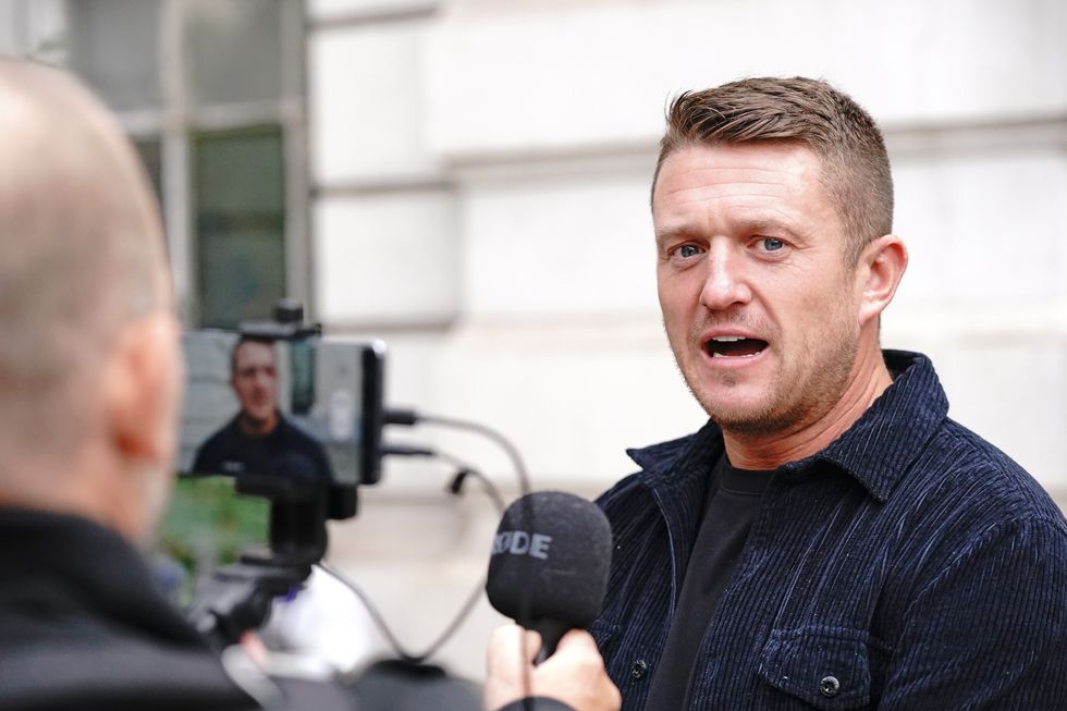 Tommy Robinson arrives at Westminster Magistrates' Court in London for a hearing regarding the stalking of a journalist