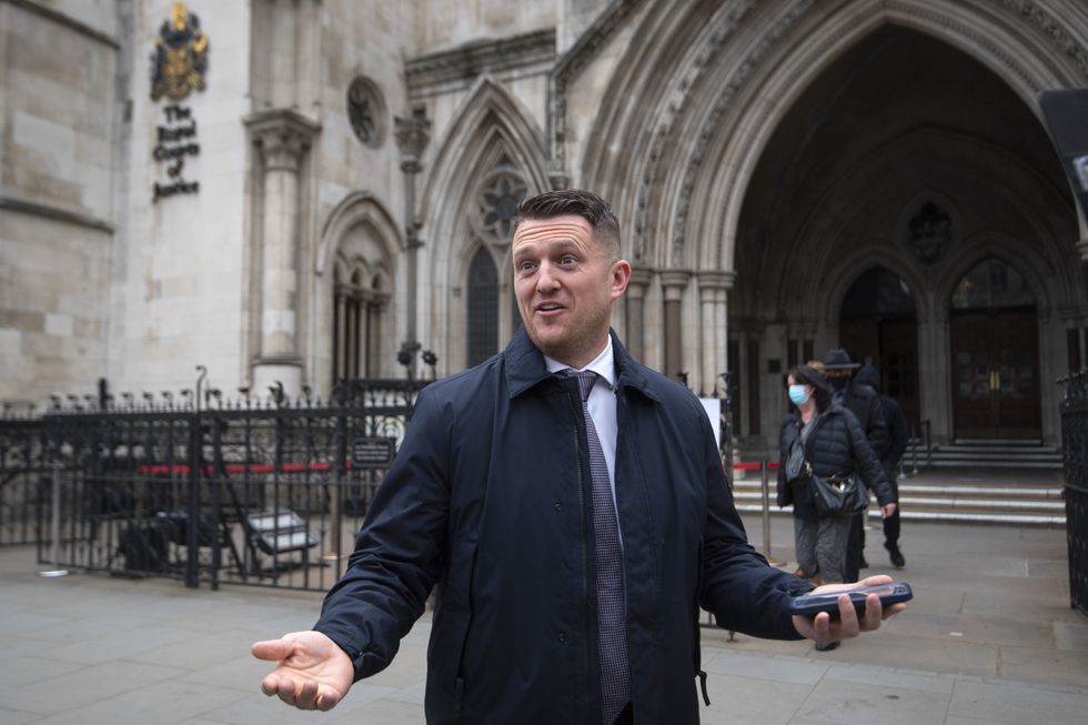 Tommy Robinson gestures outside the Royal Courts of Justice, London, for the libel case brought against him by Jamal Hijazi.