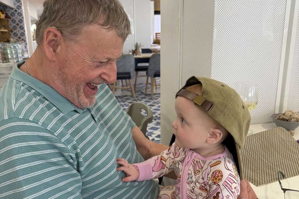 TONE holding his grandchild