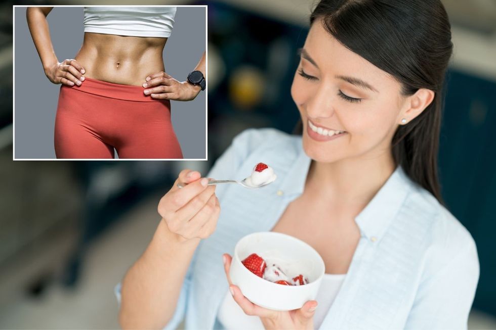 Toned female tummy / Woman eating strawberries and cream