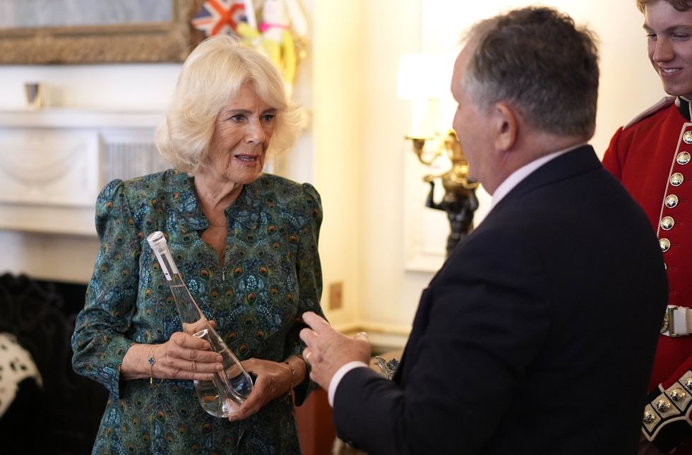 Tony Curtis presented Queen Camilla with gifts