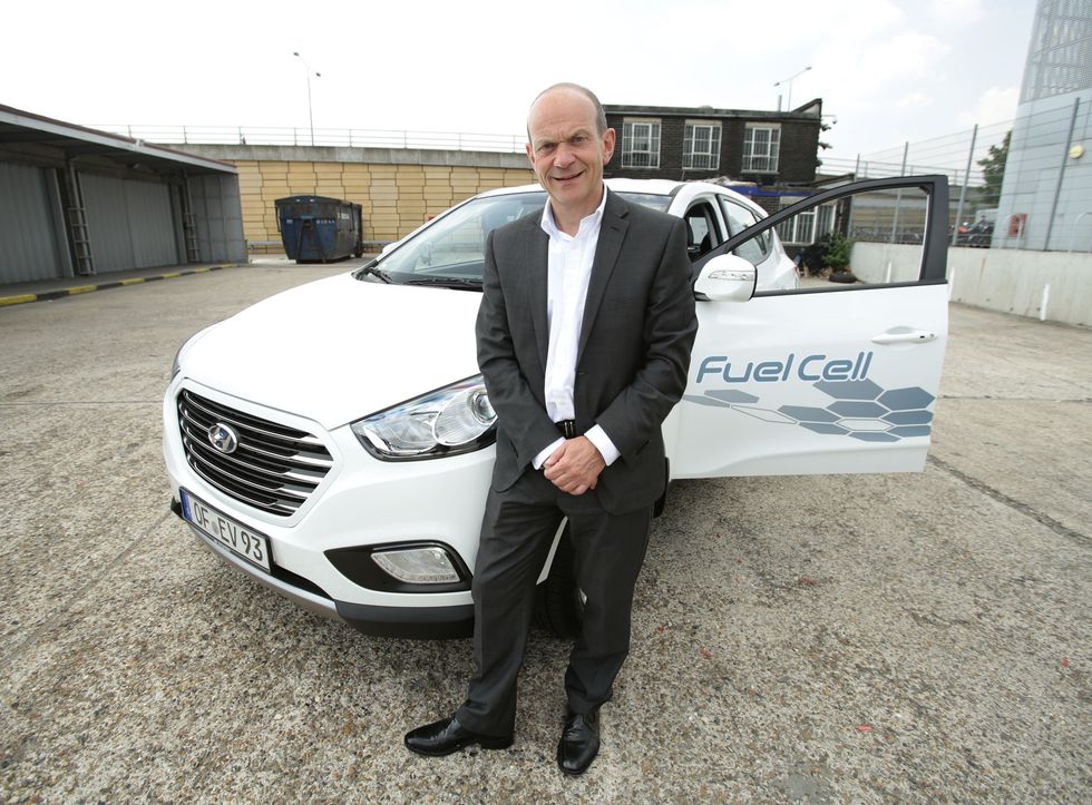 Tony Whitehorn sitting on Hyundai EV