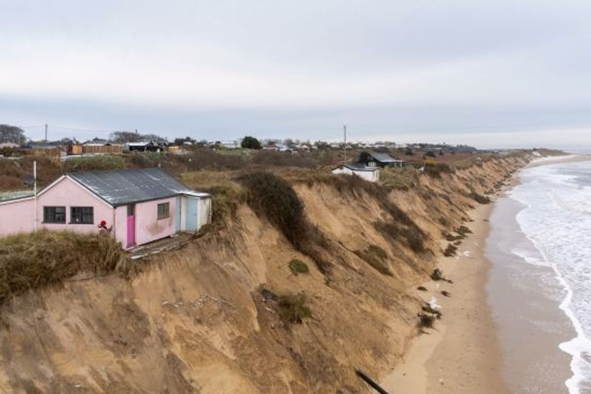 Coastal erosion causing homes in England to slide into the sea