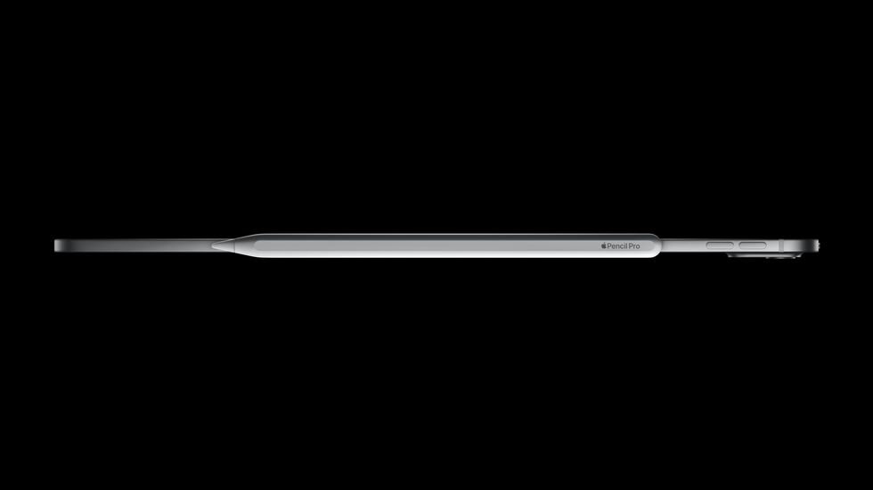 top down view of the ipad pro with the apple pencil pro snapped to the side and charging