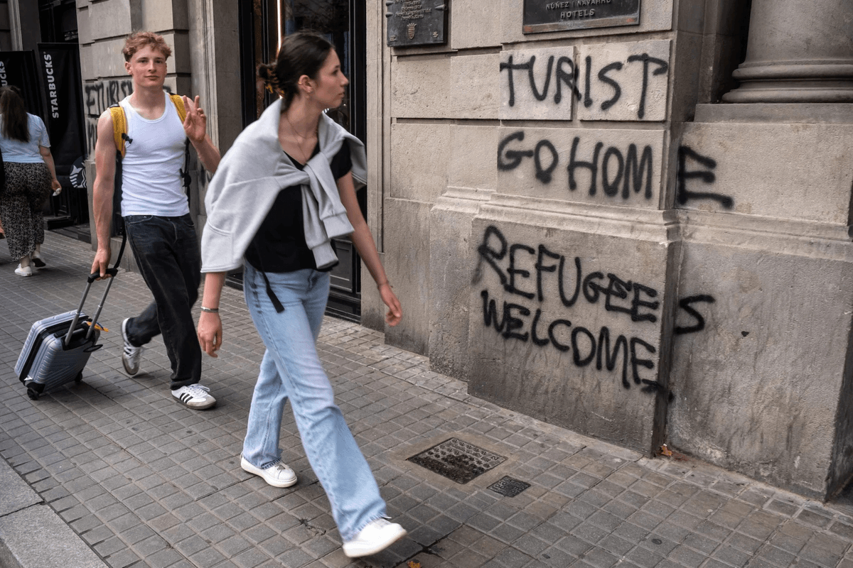 Tourist go home refugees welcome graffiti