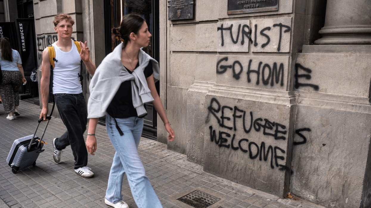 Tourist go home refugees welcome graffiti