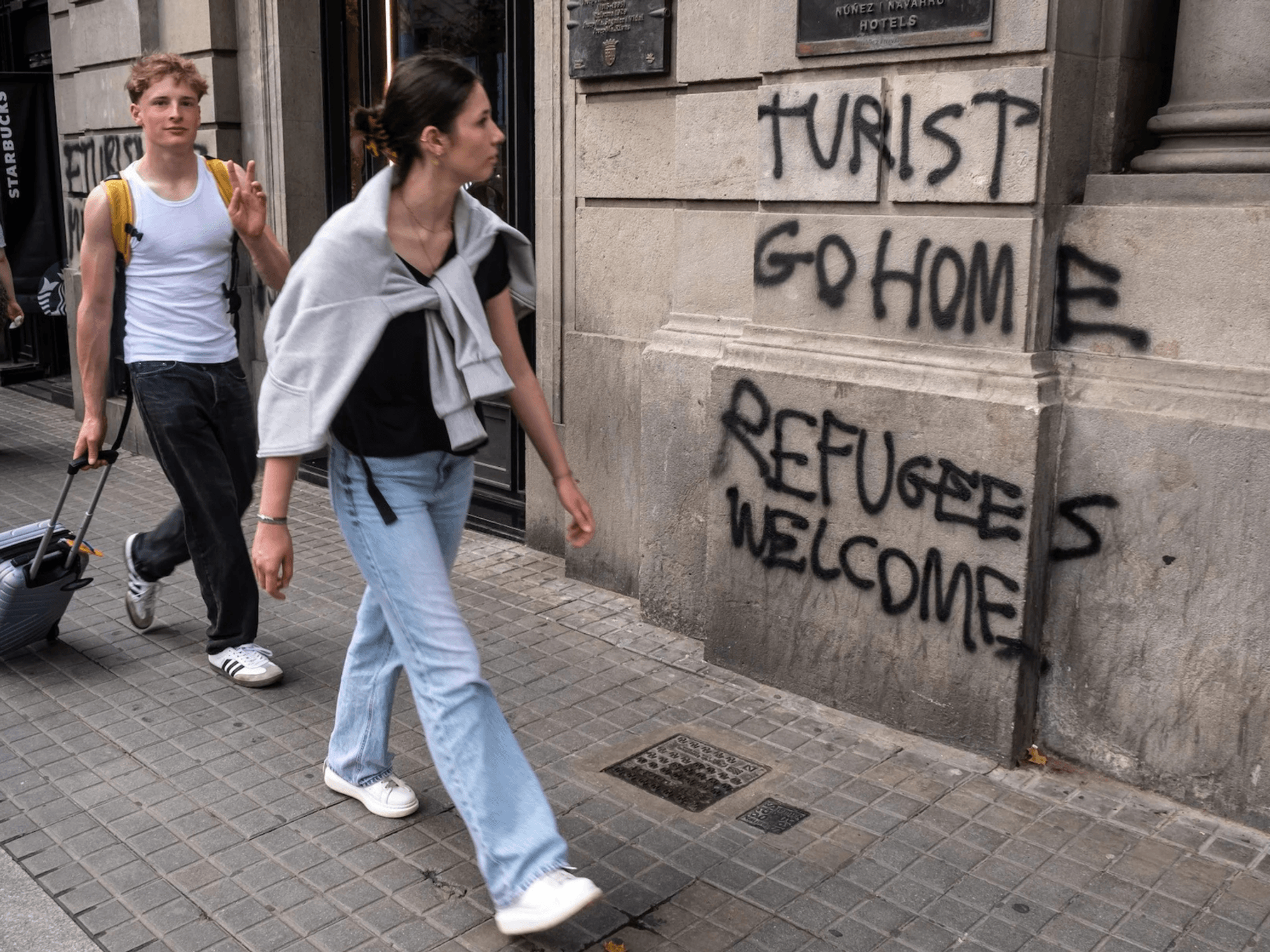 Tourist go home refugees welcome graffiti