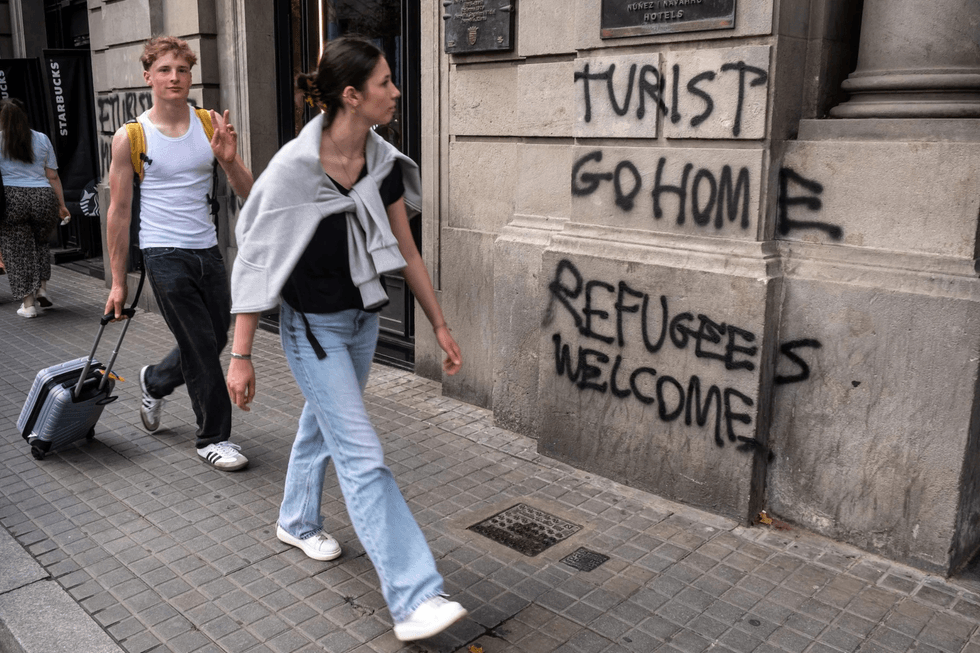 Tourist go home refugees welcome graffiti
