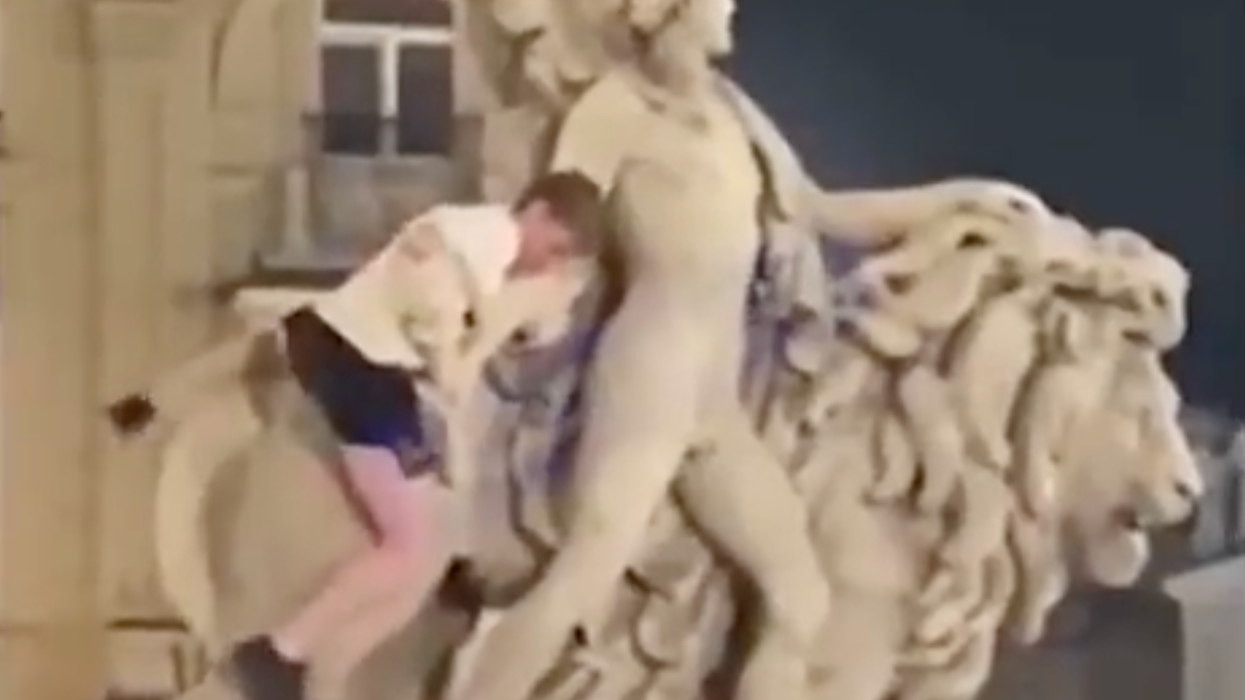 Tourist on statue in Brussels