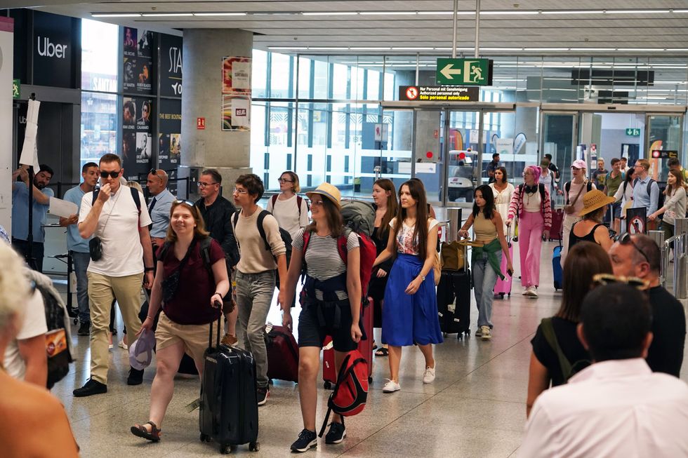 Tourists arrive at Malaga airport
