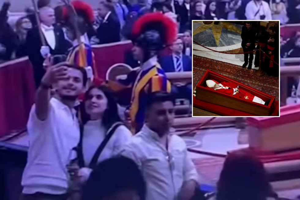 Tourists taking selfies with the body of the late pontiff has caused outrage