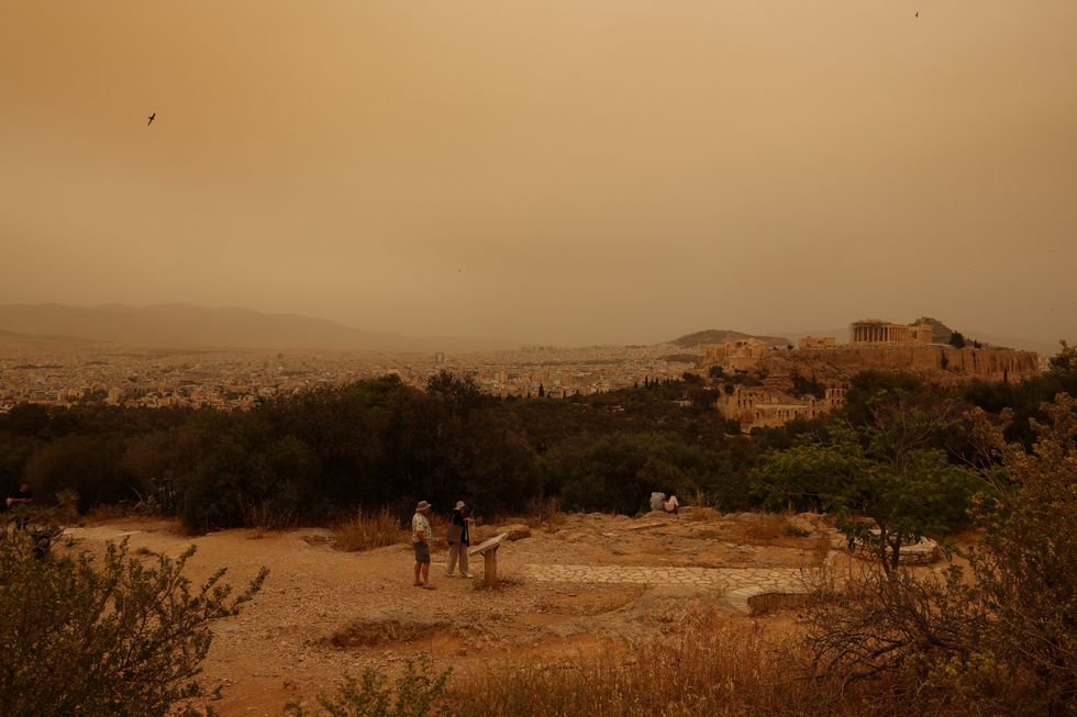 Tourists visit the Filipappou hill with the views of the Acropolis
