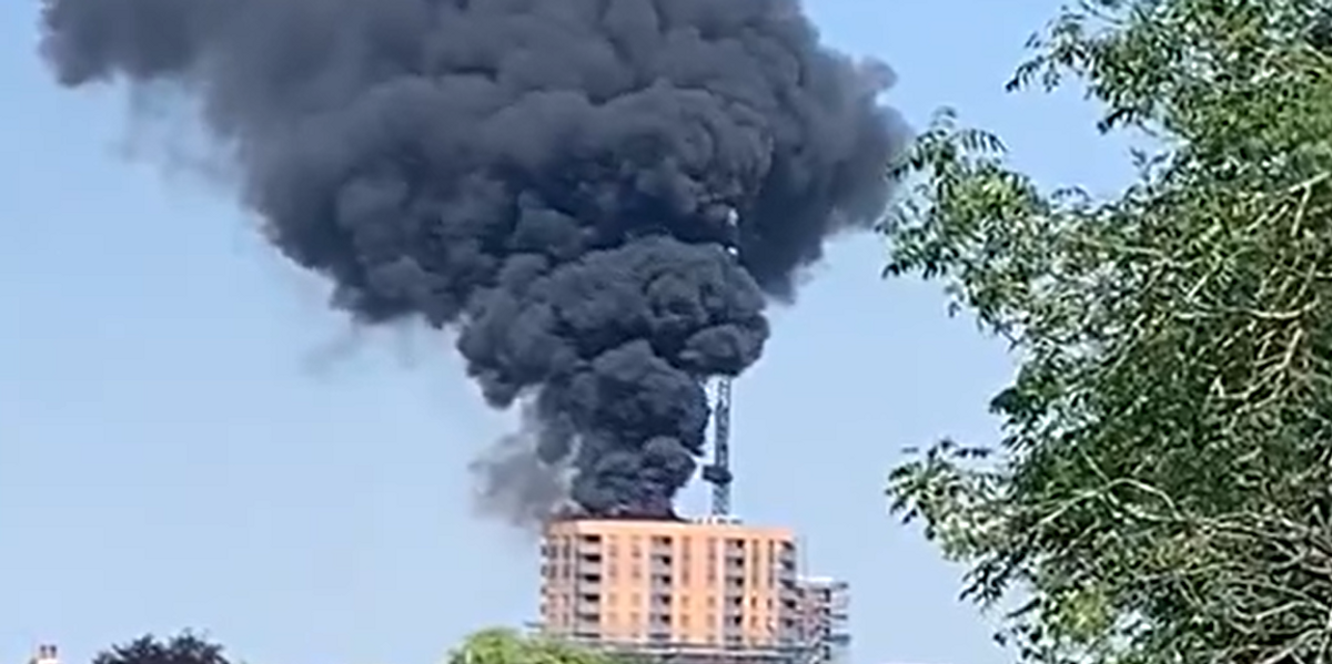 NextImg:Huge tower block erupts in flames as thick smoke engulfs building and can be seen for miles