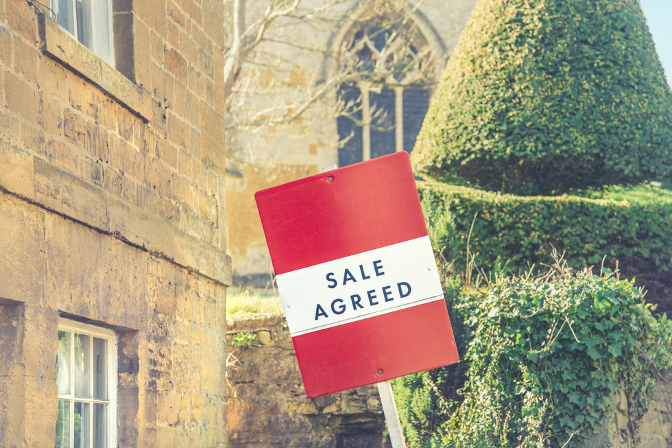 Traditional property on sale with 'Sale Agreed' sign outside