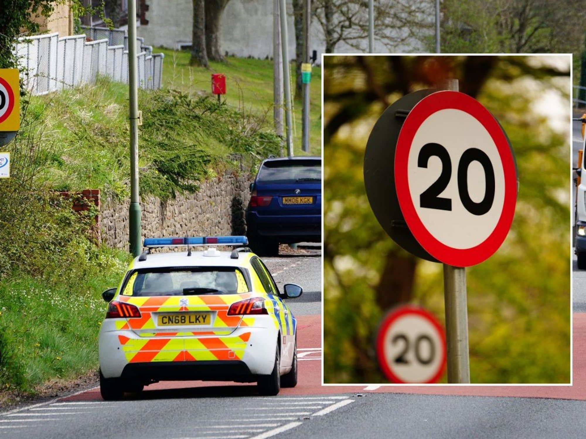 Traffic driving past a 20mph speed limit sign and a 20mph sign
