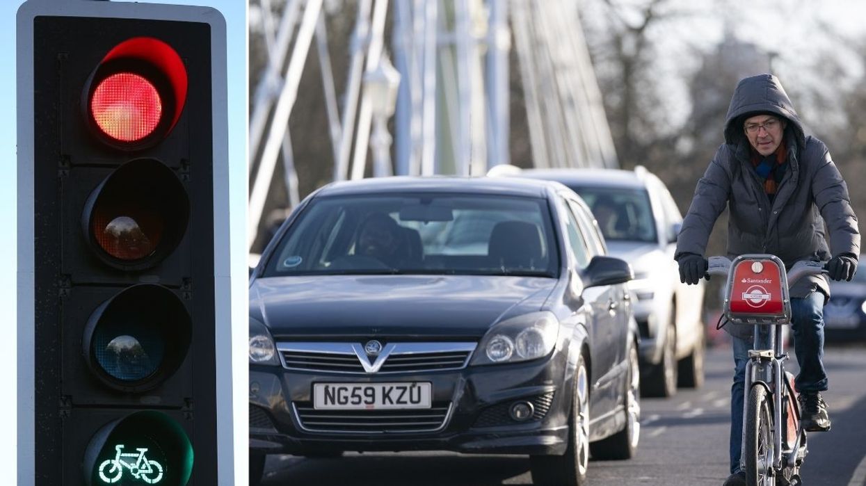 Traffic light and cyclist in traffic