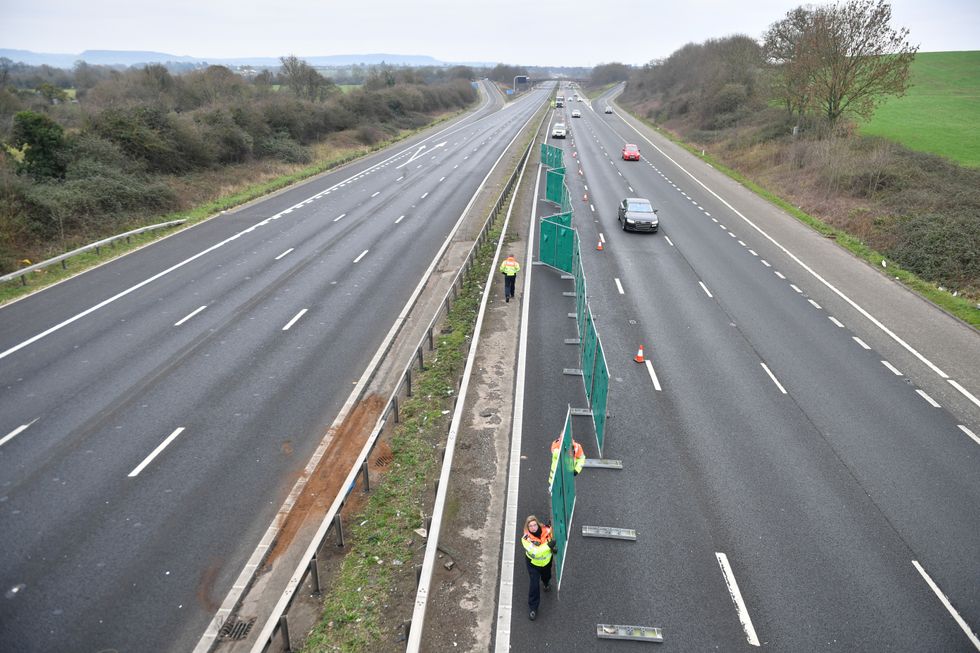 Traffic officers repairing a section of the M5 motorway barrier