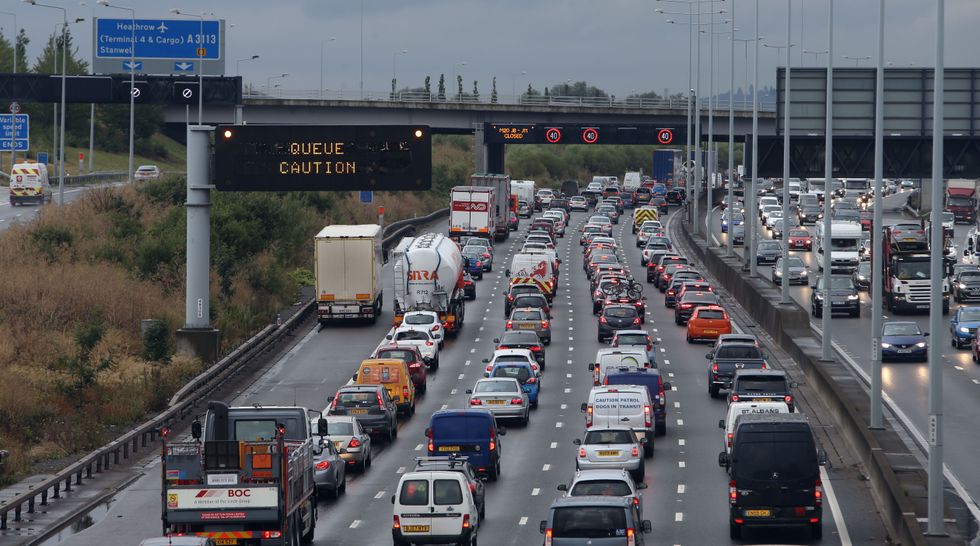 Traffic on the M25 near Colnbrook, as parts of Britain are battered by very heavy rain and winds of up to 50mph in an %22intense%22 day of unseasonably bad weather.
