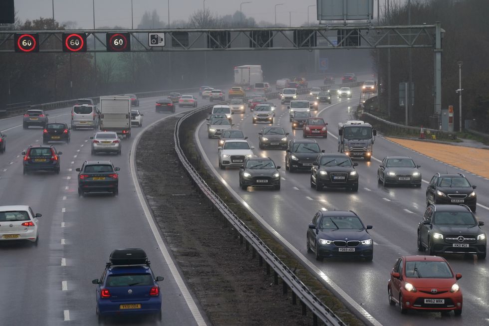 Traffic on the M42 near Birmingham. Many drivers are battling a band of heavy rain which is moving north from southern England and Wales to southern Scotland and Northern Ireland throughout the day. Picture date: Friday December 23, 2022.